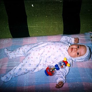 Baby sleeping peacefully with toy.