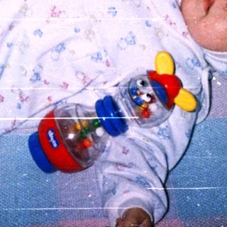 Baby sleeping peacefully with toy.