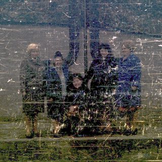 Reflection of people on a rainy window.