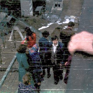 Reflection of people walking outside in winter.