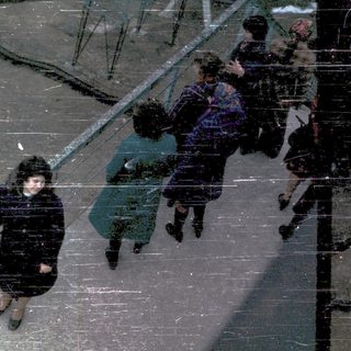 People descending stairs in rainy weather.