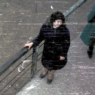 People descending stairs in rainy weather.