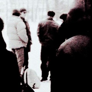People gathered outdoors in heavy snowfall.
