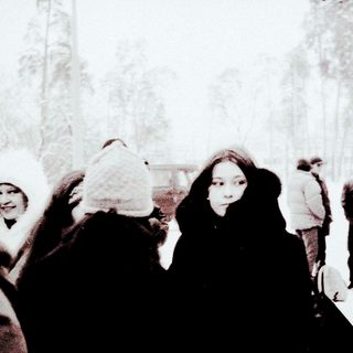 People gathered outdoors in heavy snowfall.