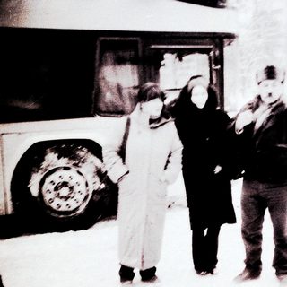 People in winter clothing near bus.