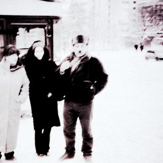People in winter clothing near bus.