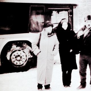People in winter clothing near bus.