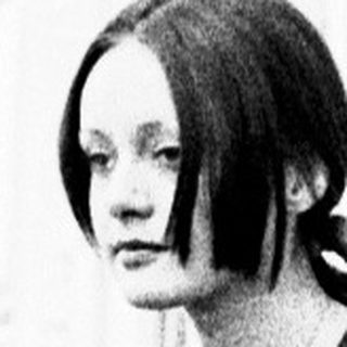 Young woman in 1960s-style dress walking confidently.