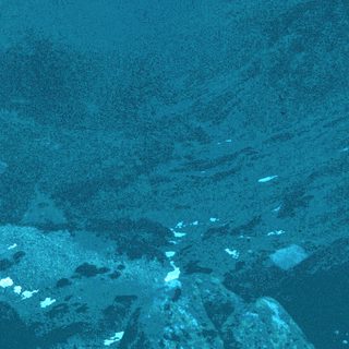 Dark ocean with scattered ice fragments.