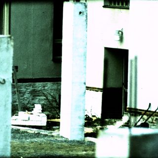 Damaged concrete structure with exposed rebar.