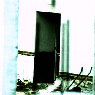 Damaged concrete structure with exposed rebar.
