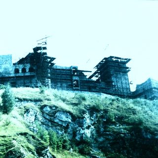 Traditional wooden fortress on hilltop.