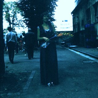 Woman holding lit torch in outdoor ceremony.