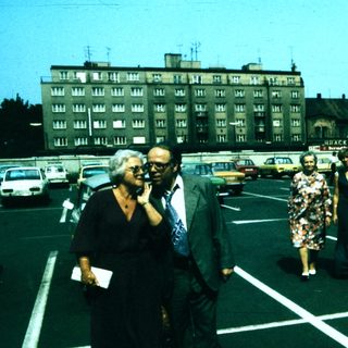 People walking in a parking lot during daytime.