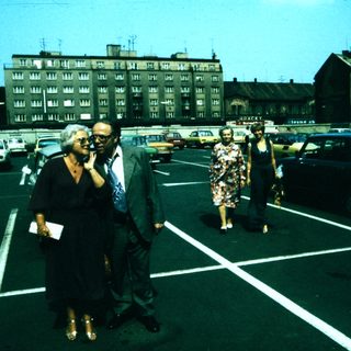People walking in a parking lot during daytime.