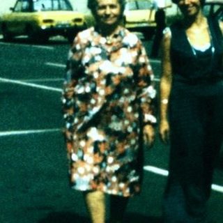 People walking in a parking lot during daytime.