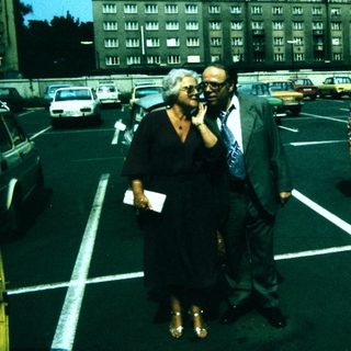 People walking in a parking lot during daytime.