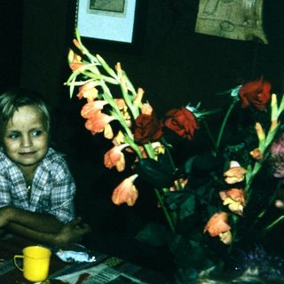 Family sitting indoors at a table with food.
