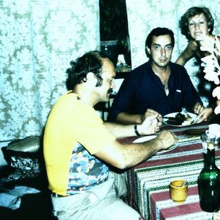 Family gathering enjoying meal indoors together.