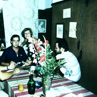 Family gathering enjoying meal indoors together.