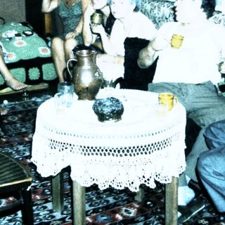 Group gathering in a living room playing card game.