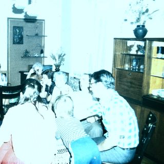 Group gathering in a room playing musical instruments.