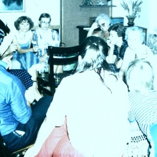 Group gathering in a room playing musical instruments.