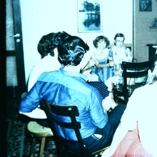 Group gathering in a room playing musical instruments.