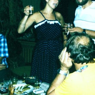 People celebrating indoors with drinks and laughter.