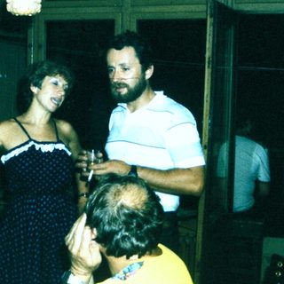 People celebrating indoors with drinks and laughter.