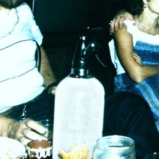 Four people gathered indoors, posing together.
