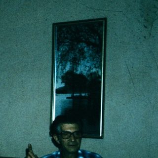 Four people gathered indoors, posing together.