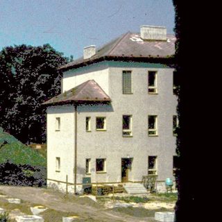 Rural landscape with old buildings and farmland.