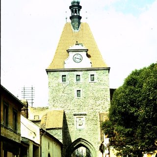 Historic stone gate tower with clock.
