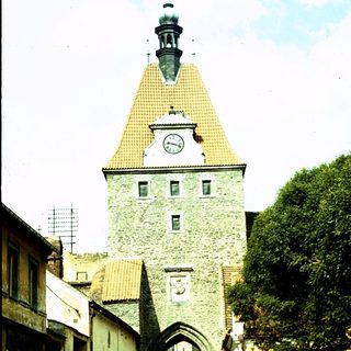 Historic stone gate tower with clock.