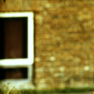 Young girl running in overgrown grass.