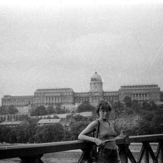 Person posing in front of Buda Castle, Budapest.