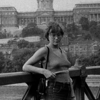 Person posing in front of Buda Castle, Budapest.