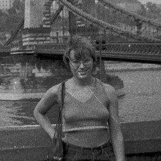 Person posing near Széchenyi Chain Bridge in Budapest.