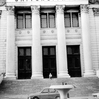 Grand neoclassical building entrance with steps.