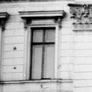 Grand neoclassical building entrance with steps.
