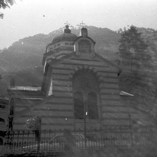 Elegant church building with mountain backdrop.