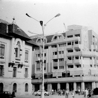 Urban street scene with mid-century buildings under construction.