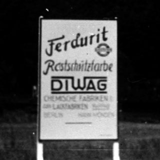 Steel bridge with "Stahlbau" sign and roadside sign for Ferdurit.