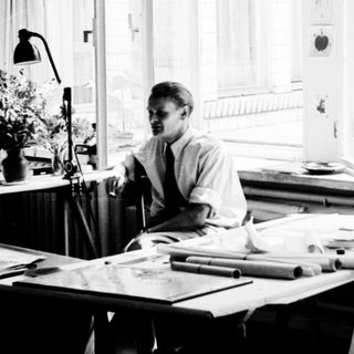 Three people working collaboratively in a bright studio.