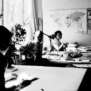 Collaborative office work in vintage setting.