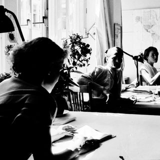 Collaborative office work in vintage setting.