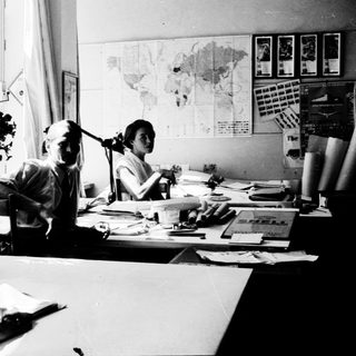 Collaborative office work in vintage setting.