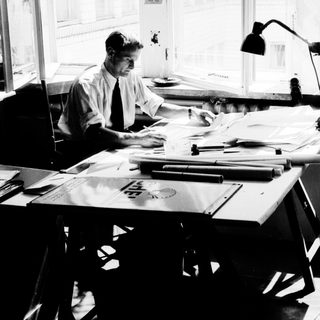 Man working at a desk with papers and documents.