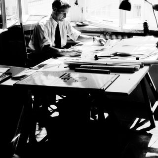 Man working at a desk with papers and documents.
